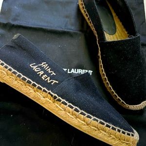 YSL-Embroidered logo letters scrawl across one side of an espadrille